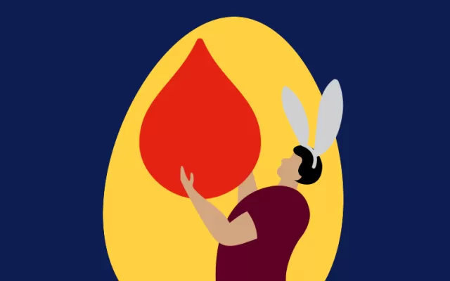 man with bunny ears holding blood drop