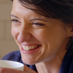 close up photo of plasma recipient Nicky smiling whilst holding cup