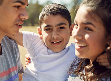 Photo of young smiling patient with family