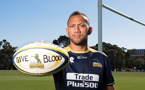 Rugby player Christian Lilinfano holding a rugby ball to call for rare blood donations