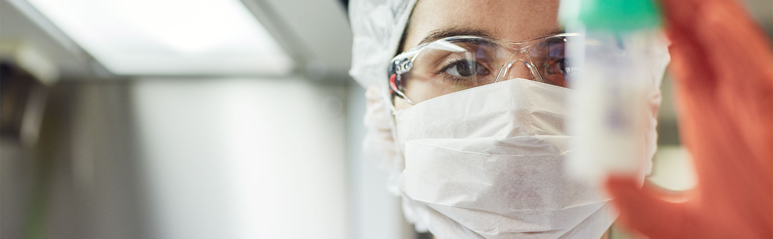 closeup of a technician holding a container