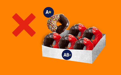 photo of a box of glazed donuts in a box, one is marked as A positive and the others are AB negative
