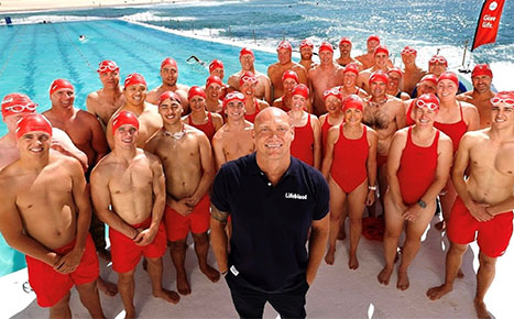 Michael Klim along with 32 donors dressed in red swimwear at Bondi