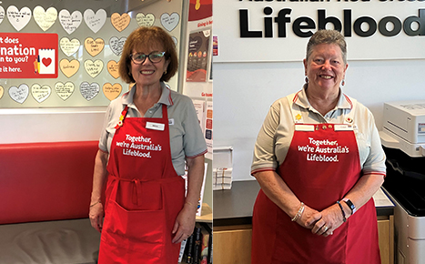 two women volunteers wearing red aprons that say 'Together, we're Australia's Lifeblood'. with a red sticker that says 'what does donation mean to you? Share it here'
