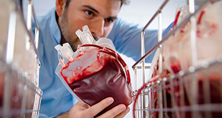 a scientist placing a blood donation onto a storage shelf