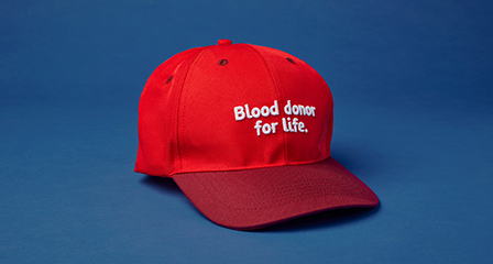 a red cap with blood donor for life written on it