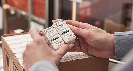 two small boxes of CSL Behring product being held