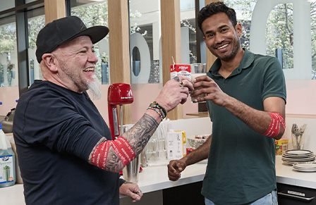 image of two male donors enjoying a post-donation snack and showing off their lifeblood branded bandages