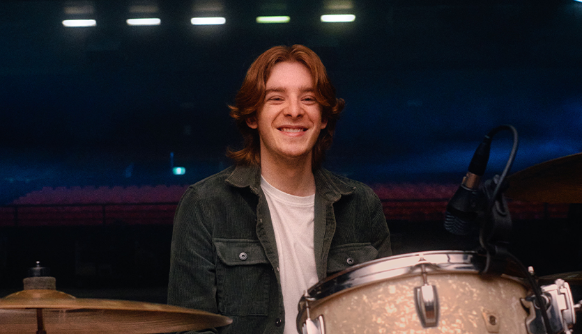 Man sitting behind drums