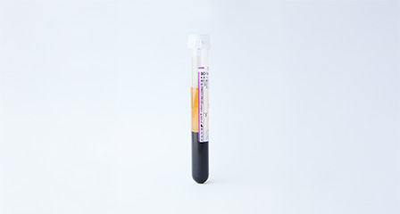 a sample container with red and clear product inside it and a label on the side