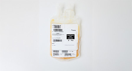 a bag containing orange coloured serum with a label on the front