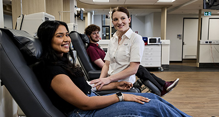 a group of people seated in donor chairs smiling