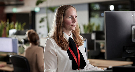 a woman seated at a desk in an office