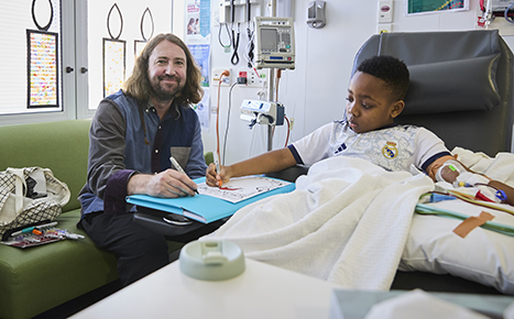 artist with child in hospital drawing