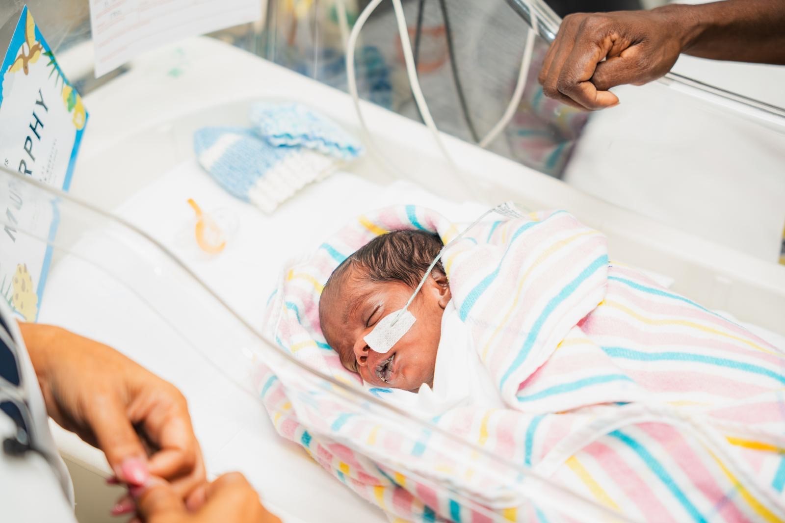 premature baby in crib in hospital