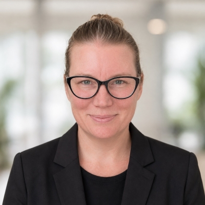 Marijke in a black jacket smiling at the camera