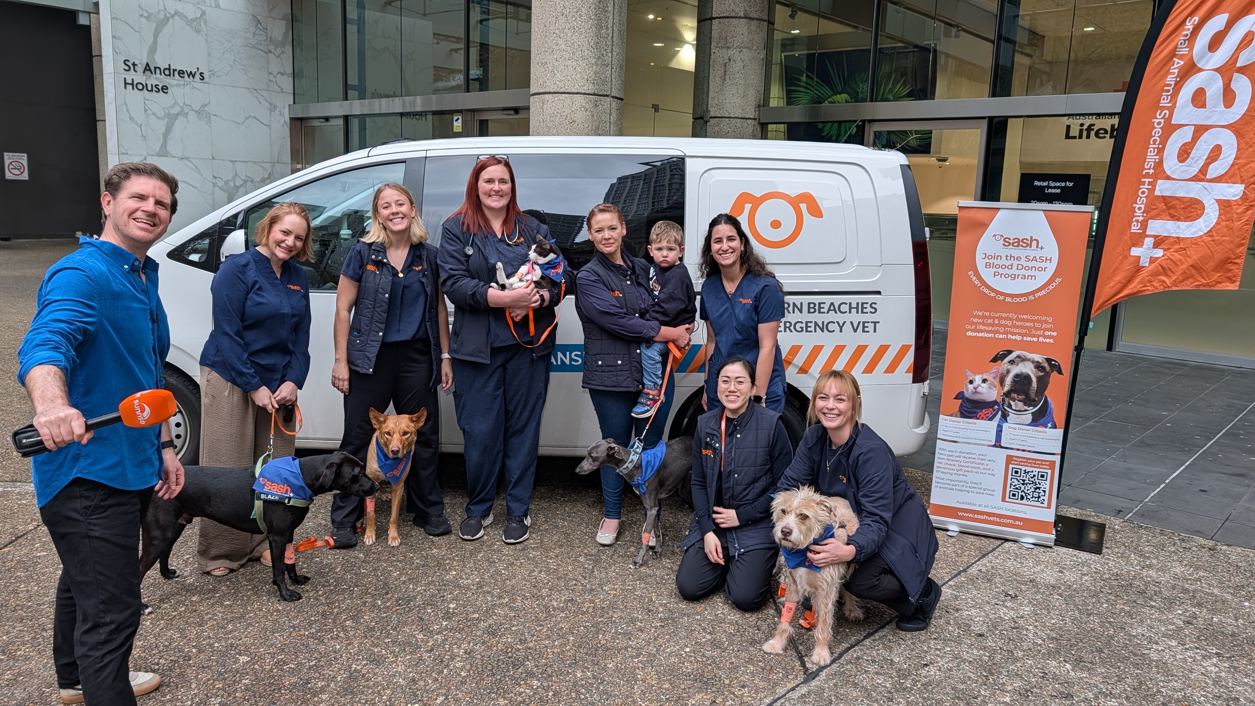 image of blood donors who are vetinarian staff with pets in front of a blood donation centre