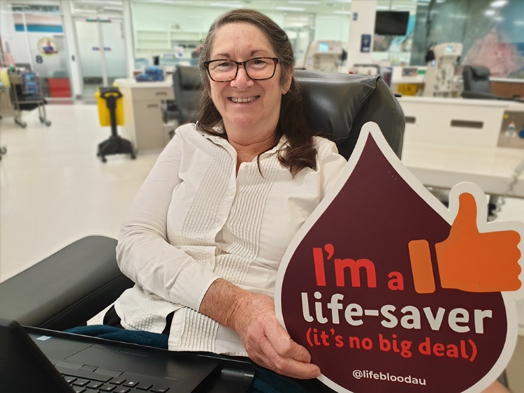 photo of robyn in a donor centre seated in a chair and smiling