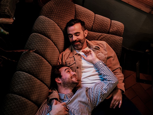 a male couple lying on a couch
