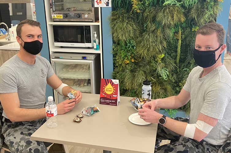 australian defence force team with snacks after donating