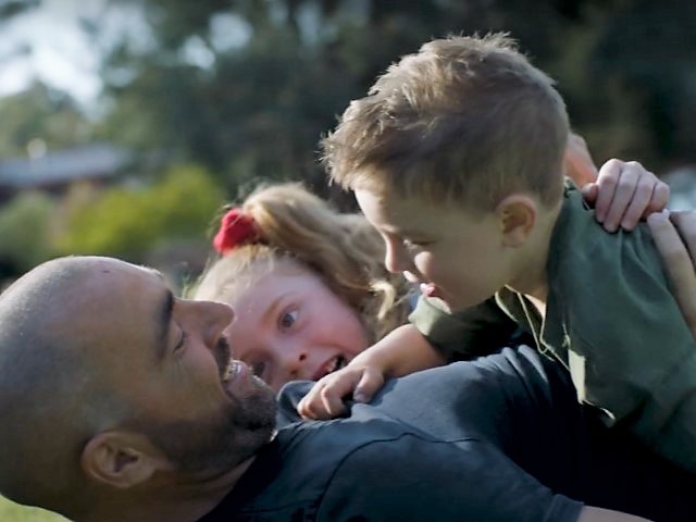 Platelet and blood recipient Gennaro playing with his kids on the grass