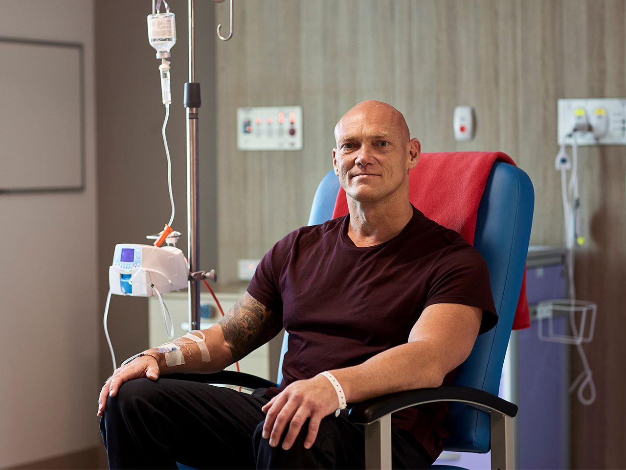 michael klim is seated and receiving a transfusion