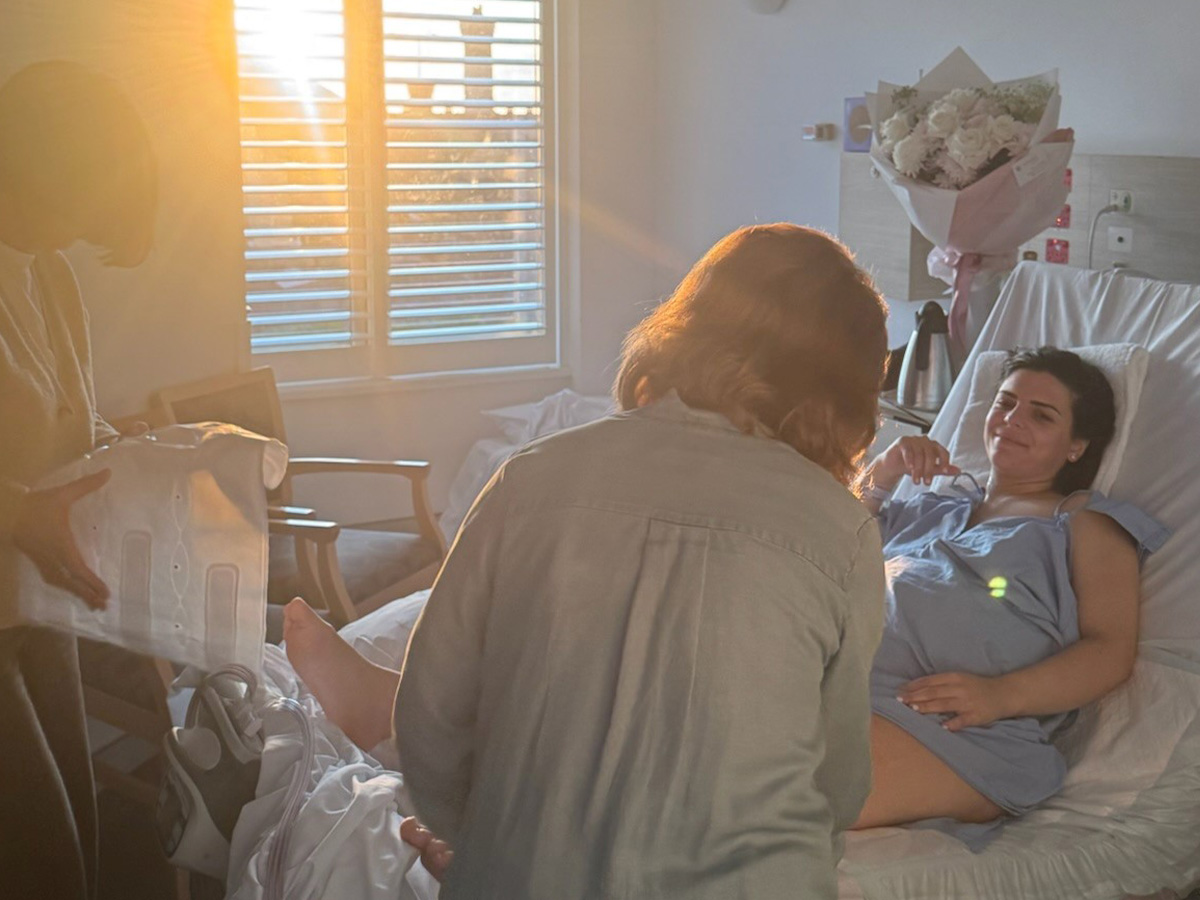 Image of a new mum in a hospital bed after giving birth