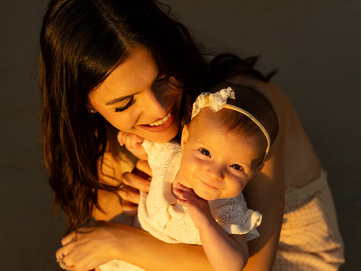 Image of a mum and her young baby girl smiling
