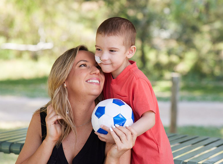 photo of a woman and a boy in a park