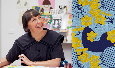 photo of artist Beci Orpin seated at a table and smiling, on the right hand side is her bandage design of a woman in dark blue outline surrounded by yellow daffodils on a pale blue background