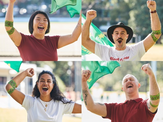 four people wearing the green and gold bandage and cheering