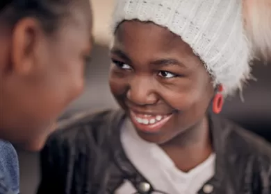 close up of two children smiling at one another