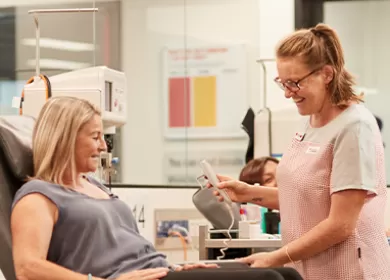 Female nurse assisting a female donor as she gives blood