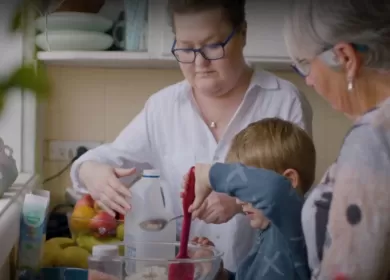 Organ donation recipient Miranda in the kitchen with her family.