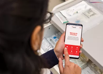 close up of a doctor using the iTransfuse app on their smartphone