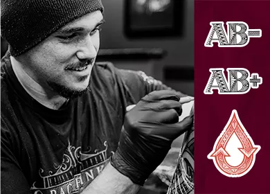 black and white photograph of tattoo artist Matiu Davidson wearing a black beanie and smiling, the three tattoo designs are on the right