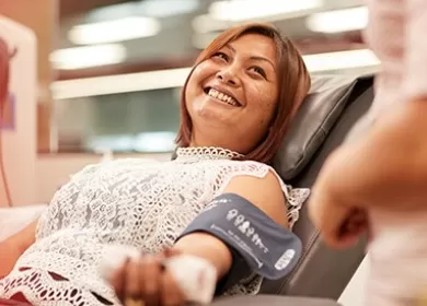photo of a donor lying back in a chair having her blood pressure taken