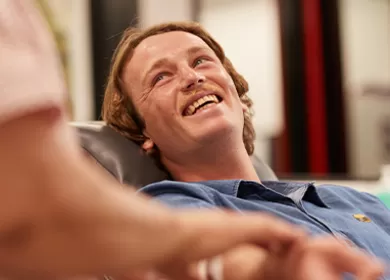 photo of a man smiling in a donor chair during a donation