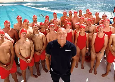Michael Klim along with 32 donors dressed in red swimwear at Bondi
