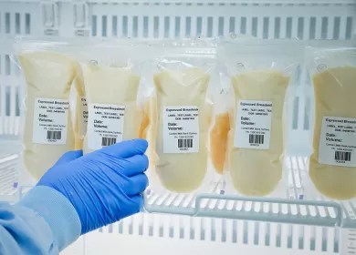 bags of donated human breast milk in fridge
