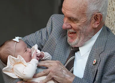 photo of a man called James Harrison holding a young baby