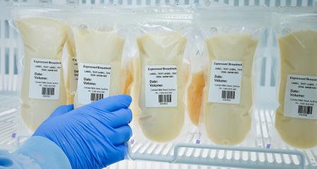 bags of donated human breast milk in fridge