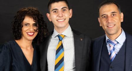 image of a teenage boy with his parents smiling at the camera
