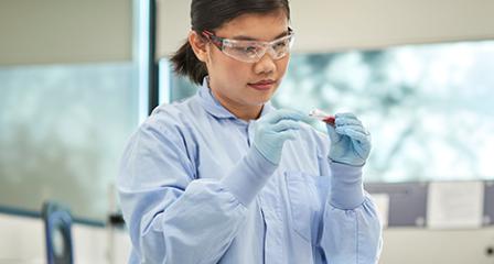Researcher looking at a blood sample in the lab
