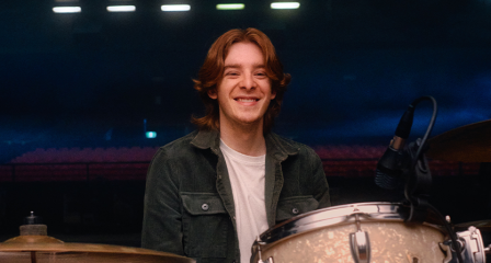 Man sitting behind drums