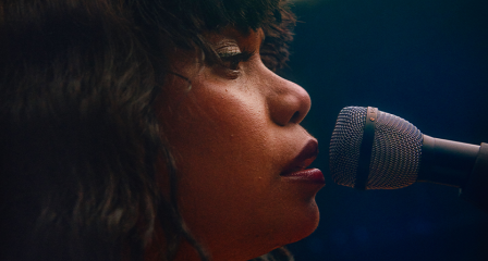 Woman singing into microphone