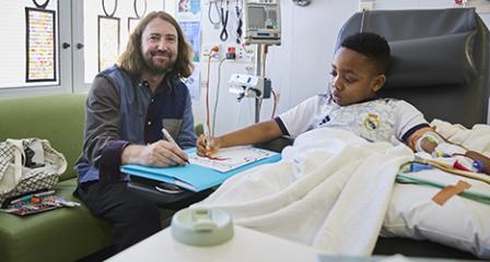 artist with child in hospital drawing