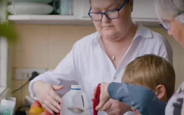 Organ donation recipient Miranda in the kitchen with her family.