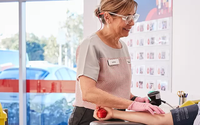 Female nurse working with female blood donor