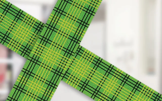 photograph of a nurse in blue scrubs wearing blue gloves putting a blood bag on a stand, to the left is the bandage design by Lisa Gorman